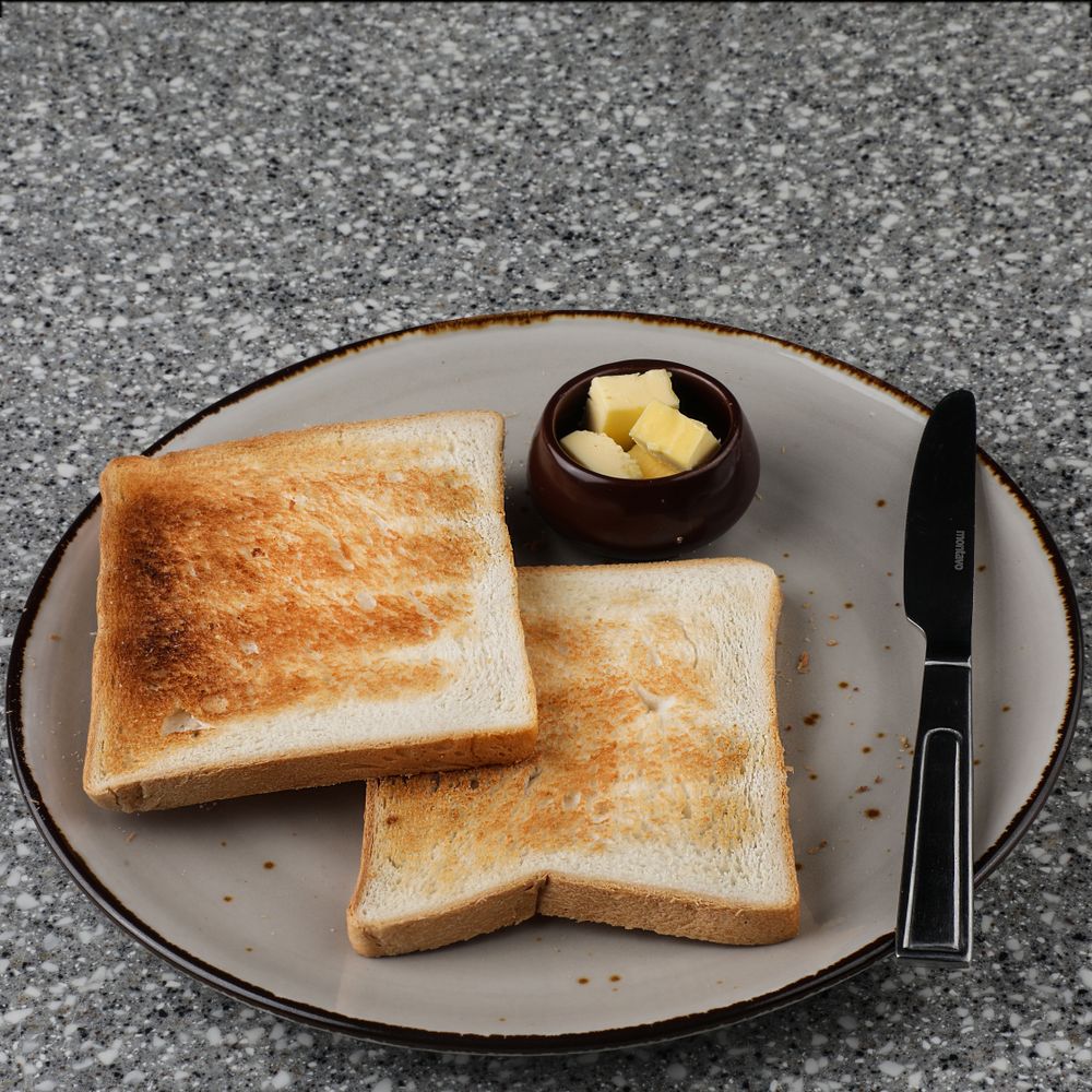 Sliced bread with butter on a breakfast table